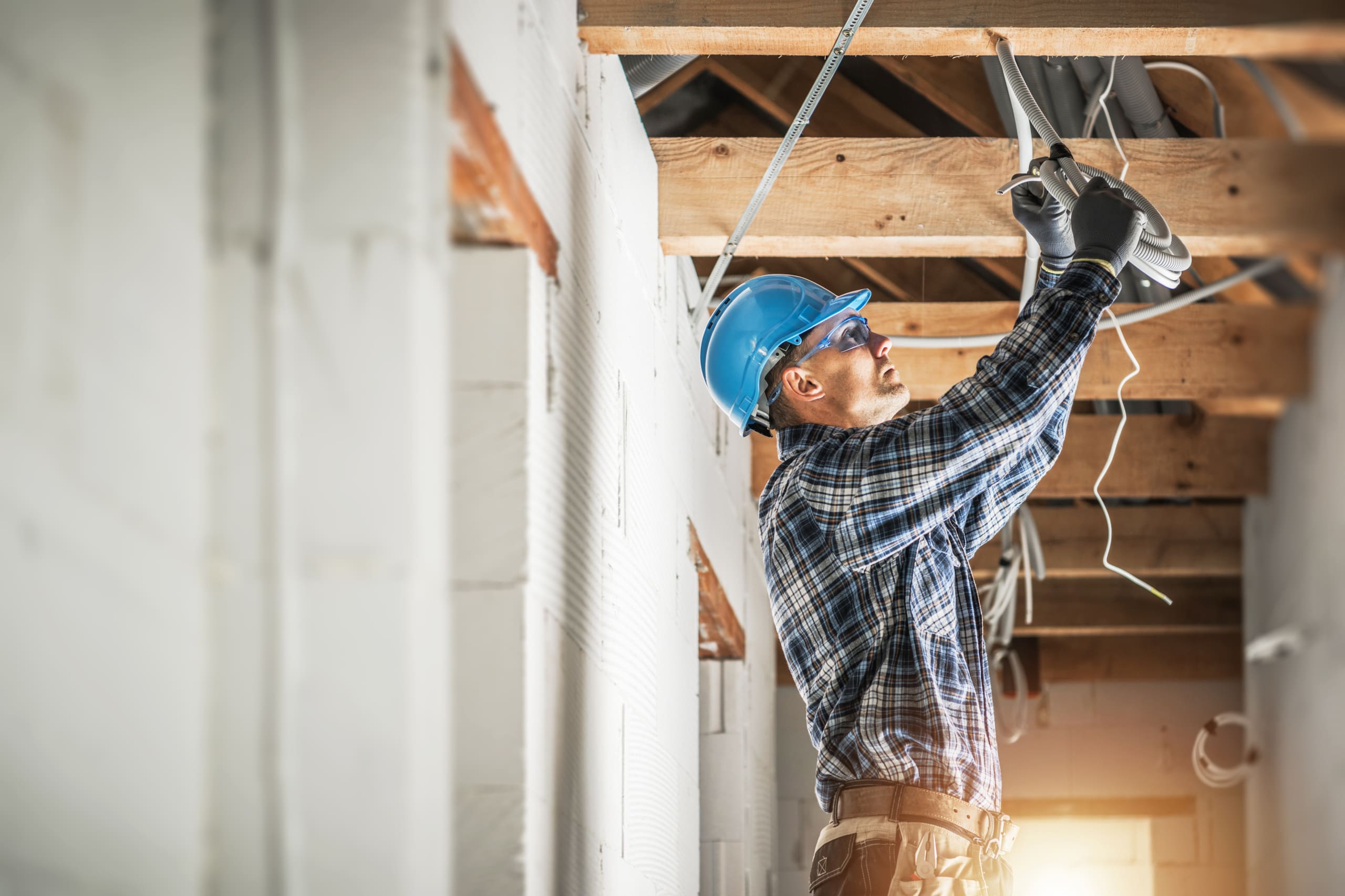 60554121 electrician installing wiring system in the ceiling scaled
